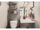 Updated bathroom with gray vanity, floating shelves, and modern fixtures at 1945 W 102Nd Ave, Thornton, CO 80260