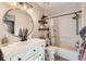 Bathroom with a bathtub, shower, vanity with floating shelves at 1945 W 102Nd Ave, Thornton, CO 80260