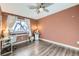 Bright bedroom with wood floors, window, and built-in workspace at 1945 W 102Nd Ave, Thornton, CO 80260