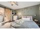 Bedroom with queen bed, barn door to bathroom, and ceiling fan at 1945 W 102Nd Ave, Thornton, CO 80260