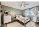 Cozy bedroom with a queen-size bed, dresser, and ceiling fan at 1945 W 102Nd Ave, Thornton, CO 80260