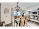 Bright dining area with table and chairs, view into living room with fireplace at 1945 W 102Nd Ave, Thornton, CO 80260