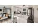 Modern kitchen with white cabinets, marble countertops, and stainless steel appliances at 1945 W 102Nd Ave, Thornton, CO 80260