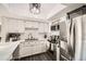 Modern kitchen with white cabinets, marble countertops, and stainless steel appliances at 1945 W 102Nd Ave, Thornton, CO 80260