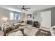 Living room with comfortable seating, fireplace, and large windows at 1945 W 102Nd Ave, Thornton, CO 80260