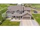 An aerial view of an attractive home, driveway, and well-manicured lawn at 7587 Wright Ct, Arvada, CO 80005