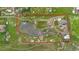 This aerial view showcases the property's expansive acreage, complete with a pond at 7587 Wright Ct, Arvada, CO 80005