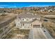 Aerial view of two-story house with stone exterior and large yard at 7587 Wright Ct, Arvada, CO 80005