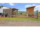 A rustic animal pen with chickens, goats, and wooden structures at 7587 Wright Ct, Arvada, CO 80005