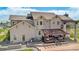 This backyard features a covered pergola, a stone patio, a built-in grill, and ample seating at 7587 Wright Ct, Arvada, CO 80005
