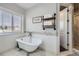 A relaxing bathroom with a freestanding tub, decorative shelves, and shower at 7587 Wright Ct, Arvada, CO 80005
