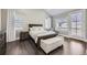 Bright bedroom with large windows, hardwood floors, and comfortable furnishings at 7587 Wright Ct, Arvada, CO 80005