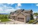 Angle view of an attractive home featuring stone accents, a garage, and an inviting outdoor space at 7587 Wright Ct, Arvada, CO 80005