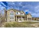 Two-story stone house with attached garage and landscaping at 7587 Wright Ct, Arvada, CO 80005