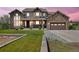 Charming stone and stucco two-story home with an attached two-car garage, landscaped yard, and inviting front entrance at 7587 Wright Ct, Arvada, CO 80005