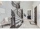 Elegant foyer featuring a curved staircase, tile floors, and access to a home office at 7587 Wright Ct, Arvada, CO 80005