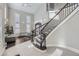 Grand foyer with a curved staircase, high ceilings, and abundant natural light at 7587 Wright Ct, Arvada, CO 80005