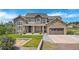 Charming home boasts a stone and stucco exterior with well-manicured landscaping and an attached garage at 7587 Wright Ct, Arvada, CO 80005