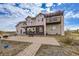 Two-story house with stone and stucco exterior, pergola, and patio at 7587 Wright Ct, Arvada, CO 80005