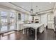 Bright kitchen with white cabinets, a large center island, and pendant lighting at 7587 Wright Ct, Arvada, CO 80005