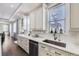 A gourmet kitchen featuring white cabinetry, granite countertops, and stainless steel appliances at 7587 Wright Ct, Arvada, CO 80005