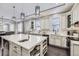 A spacious kitchen features a large island, stainless appliances, and abundant natural light at 7587 Wright Ct, Arvada, CO 80005
