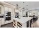 A gourmet kitchen features a large island, stainless appliances, and open layout at 7587 Wright Ct, Arvada, CO 80005