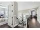 Bright foyer showcases hardwood floors and curved staircase with ornate iron railings at 7587 Wright Ct, Arvada, CO 80005
