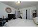 Cozy bedroom featuring mirrored closet doors, a decorative mirror, and a soft, neutral color palette at 865 S Quebec St # 302A, Denver, CO 80247