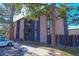 Exterior view of a well-maintained apartment building with balconies and mature trees at 865 S Quebec St # 302A, Denver, CO 80247