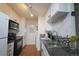 Functional kitchen features white cabinets, contrasting countertops, and modern track lighting at 865 S Quebec St # 302A, Denver, CO 80247