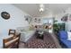 Sunlit living room with a ceiling fan, access to a balcony, and inviting sofas at 865 S Quebec St # 302A, Denver, CO 80247