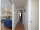 Hallway view into a well-lit living room and a glimpse of the adjacent bedroom at 865 S Quebec St # 302A, Denver, CO 80247