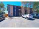 Exterior view of apartment building with parking spaces and landscaped areas at 865 S Quebec St # 302A, Denver, CO 80247
