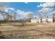 Large backyard featuring a fence, some trees, and sunny exposure at 1970 Willow St, Denver, CO 80220