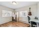 Bright bedroom with hardwood floors, two windows, and shelf storage at 1970 Willow St, Denver, CO 80220