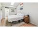 Bright bedroom featuring a skylight, wood floors, and neutral decor at 1970 Willow St, Denver, CO 80220