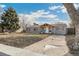 Quaint gray home with a covered porch and mature trees in the front yard at 1970 Willow St, Denver, CO 80220