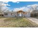 Charming single-story home features a cozy front porch, gray exterior paint, and decorative wooden shutters at 1970 Willow St, Denver, CO 80220