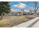 Inviting single-story home with a gray exterior, wooden accents, and a well-maintained front yard in a residential neighborhood at 1970 Willow St, Denver, CO 80220