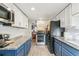 Well-lit kitchen with stainless steel appliances, granite countertops, and two-tone cabinets at 1970 Willow St, Denver, CO 80220
