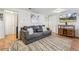 Cozy living room featuring a gray sofa, decorative pillows, wood floors, and stylish decor at 1970 Willow St, Denver, CO 80220