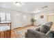 Bright living room with hardwood floors, a gray sofa, and a view of the front door at 1970 Willow St, Denver, CO 80220