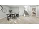 Inviting dining area adjacent to the staircase, featuring modern furniture and a minimalist design at 635 Fillmore St, Denver, CO 80206