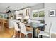 Dining area with modern table, ample seating, and natural light adjacent to the kitchen at 635 Fillmore St, Denver, CO 80206