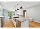 Spacious kitchen with a large island and a view into the dining area and outdoor space at 635 Fillmore St, Denver, CO 80206