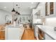 Bright kitchen featuring a center island, stainless steel appliances, and herringbone backsplash at 635 Fillmore St, Denver, CO 80206