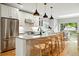 Modern kitchen featuring a large island, stainless steel appliances, and stylish pendant lighting at 635 Fillmore St, Denver, CO 80206