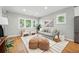 Open-concept living room featuring hardwood floors, bright windows, and modern furniture at 635 Fillmore St, Denver, CO 80206