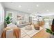 Bright living room featuring hardwood floors, a modern rug, and an open concept to the kitchen at 635 Fillmore St, Denver, CO 80206